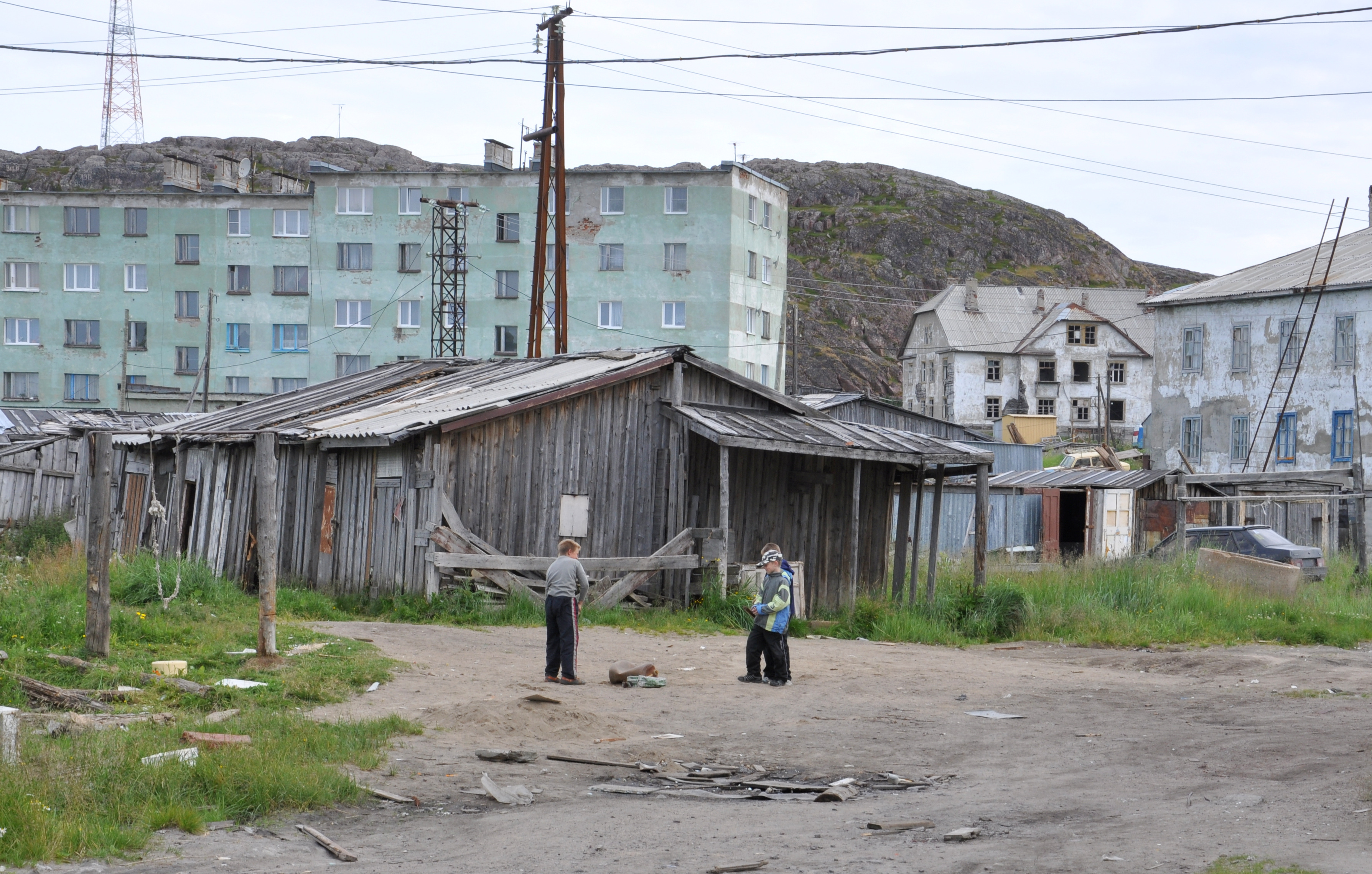 Children playing among apartment houses from Khrushchev and Stalin era. Teriberka, Kola Peninsula, July 2011. Photo: Þóra Pétursdóttir